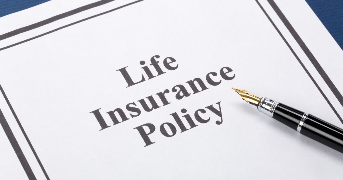 Life insurance policy paperwork and pen