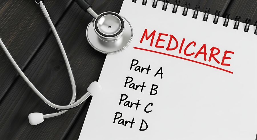 Medicare health insurance document with stethoscope on black background showing parts A B C D for medical coverage concept